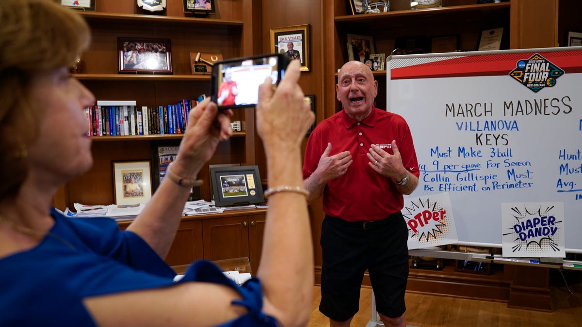 Dick Vitale, an analyst and champion of college basketball for more than four decades on ESPN, begins to get his voice back and records video clips with the help of his wife Lorraine McGrath. He is analyzing NCAA Tournament matchups as he recovers from cancer treatment and vocal cord surgery at his home in Lakewood Ranch, Florida.