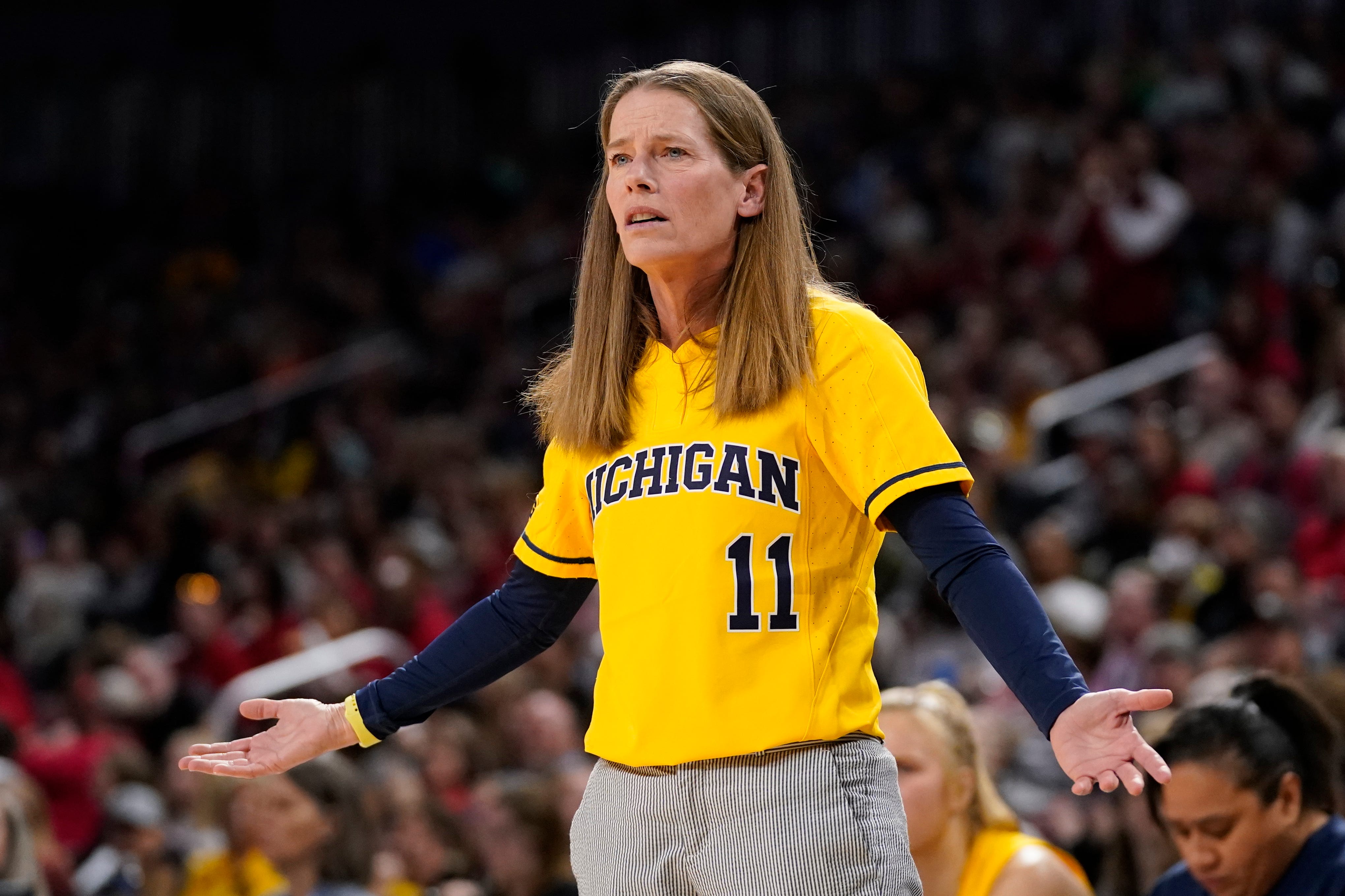 Michigan women's basketball head coach Kim Barnes Arico said she needed 29 male practice players to scrimmage with the 14 women on her team. Michigan's athletic department counted all those men as female athletes in its 2018-19 report to the federal government.