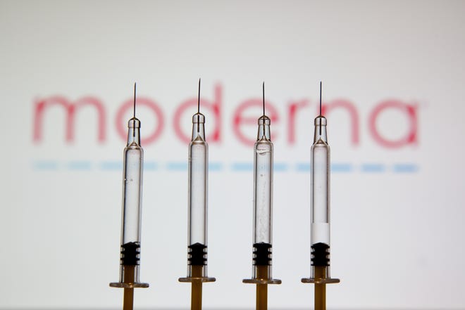 In a photo illustration, medical syringes seen displayed in front of the logo of pharmaceutical giant Moderna. Moderna and Pfizer have asked for emergency authorization of a second booster for elderly and vulnerable citizens. (Konstantinos Zilos/SOPA Images/Zuma Press/TNS)