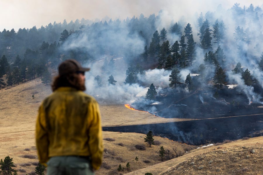 A firefighter watches the blaze in Boulder, Colo., which forced almost 20,000 people to evacuate their homes.
