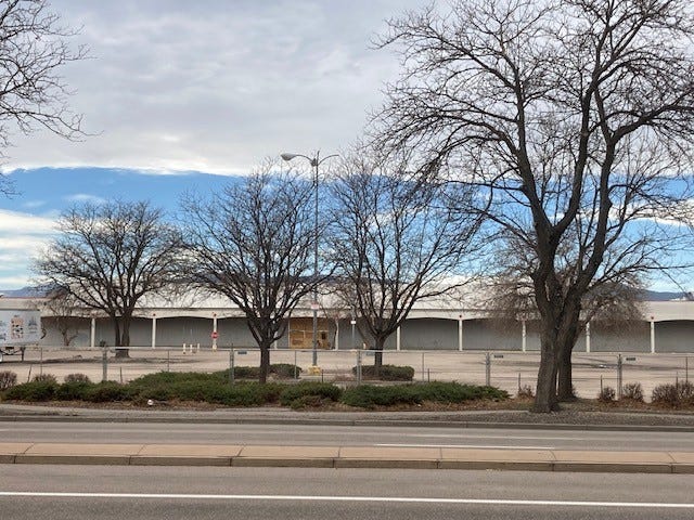 Construction fencing has been erected on the east side of the former Kmart shopping center as the site gets ready for redevelopment.