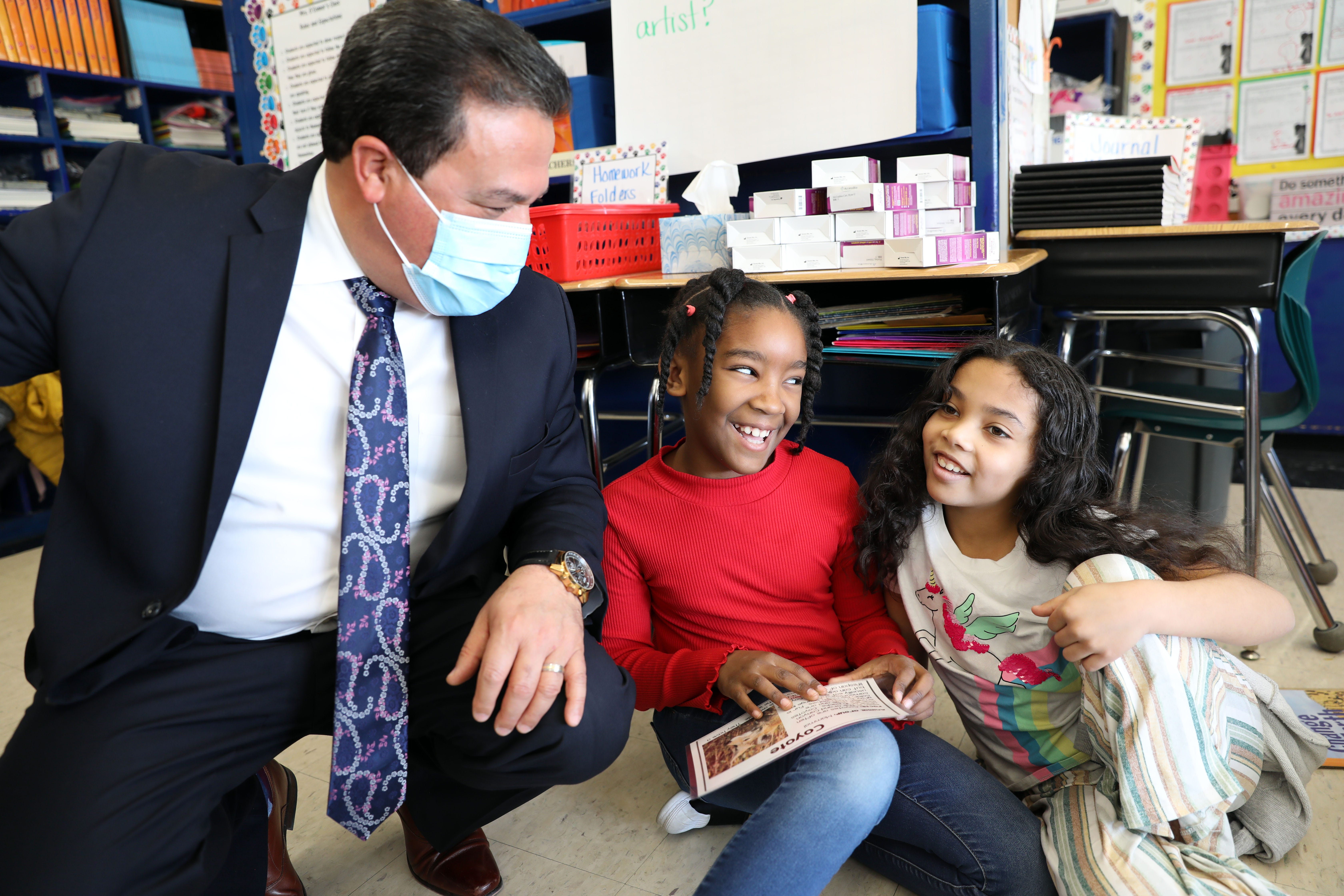 Edwin M. Quezada, superintendent of the Yonkers Public Schools, looks on as second-graders Ormariez Pina, center, and Albania Sanchez work on a research project about the Grand Canyon at School 30 March 8, 2022 in Yonkers.