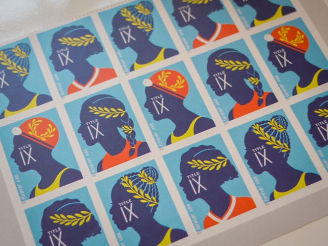 A page of Title IX commemorative stamps belonging to Kitty Bayh, widow of former Indiana senator Birch Bayh, is seen in her home in Easton, Md. on March 24, 2022. Birch Bayh, the former United States Senator from Indiana was the author of Title IX. 