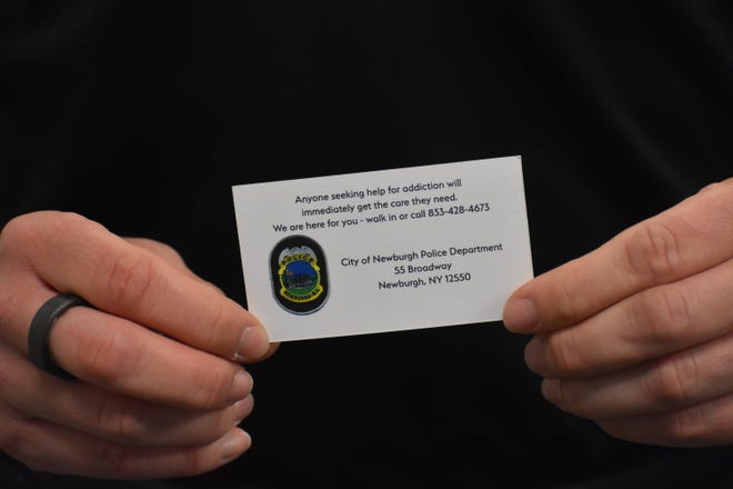 City of Newburgh police Sgt. Jessica Brooks shows a business card with information about the Hope Not Handcuffs program.  The program aims to help people battling addiction.