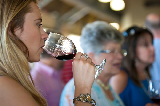 Brooke Foley tries a wine during the Food & Wine Festival on Thursday, April 28, 2016, at River Market in Tuscaloosa. This year's festival is set for April 7.