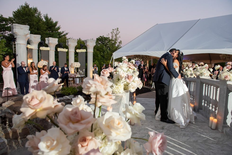 Flowers at John Tsiamtsiouris and Nicole Psomas Tsiamtsiouris' wedding at The Meadow Wood in Randolph, New Jersey, were designed by Premier Events by Reema.