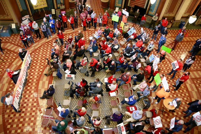 About 100 concerned landowners and pipeline opponents from across Iowa gather in the rotunda of the state Capitol in Des Moines on Tuesday to voice their concerns about the use of eminent domain for proposed pipelines.