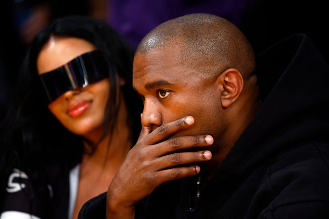 Rapper Kanye West and girlfriend Chaney Jones attend a game between the Washington Wizards and the Los Angeles Lakers in the fourth quarter at Crypto.com Arena on March 11, 2022 in Los Angeles, California.
