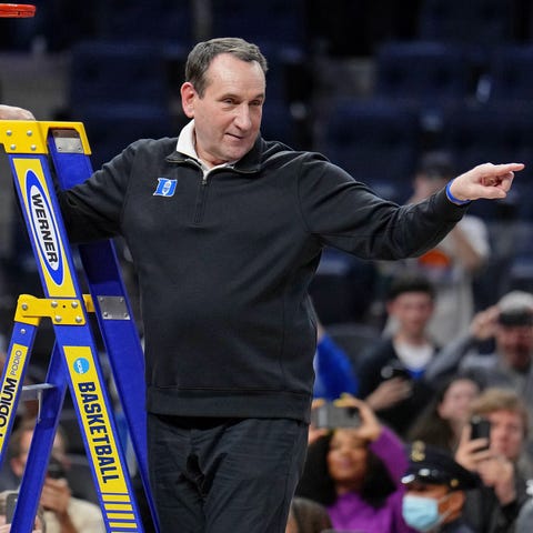 Duke coach Mike Krzyzewski gestures as he cuts dow