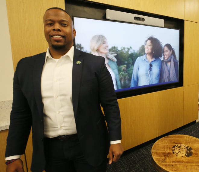 Dominic Wright, Communications Manager talks about the J.P. Morgan space in House Three Thirty during a media tour before the public open house in Akron.