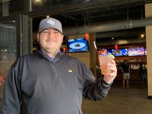 Solé Augusta manager Will Williamson enjoys a drink at his restaurant and bar in downtown Augusta.