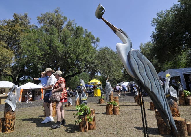Art patrons look at the carved wooden birds of South Carolina artist Steve Umphrey at 2011's Mandarin Art Festival. This year's show returns from a COVID-19 hiatus Saturday and Sunday at the Mandarin Community Club at 12477 Mandarin Road.