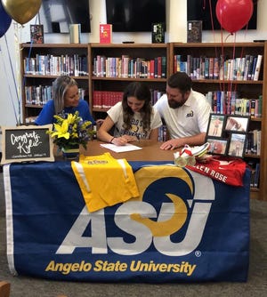 Flanked by her parents Nicole Frush, left, and Kyle Frush, Glen Rose senior Kylie Frush, center, signed a national letter of intent to run track at Angelo State University in front of family and friends at the Glen Rose High School Library last Friday.