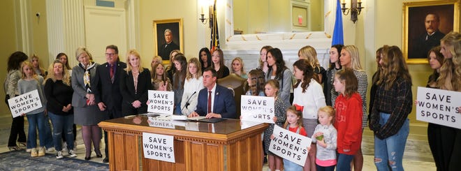 Governor Kevin Stitt signs SB2, the Save Women in Sports Act, in the Blue Room at the Capitol Wednesday, March 30, 2022. 