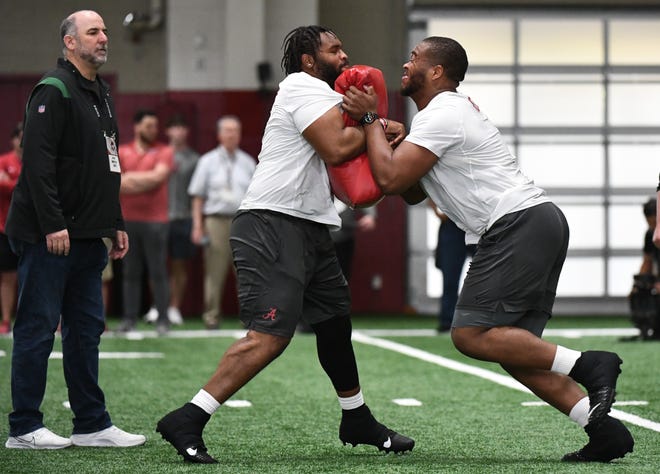 Mar 30, 2022;  Tuscaloosa, AL, USA;  Alabama offensive lineman Chris Owens (79) and Alabama offensive lineman Evan Neal (73) work through a drill for NFL scouts during the University of Alabama's Pro Day at Hank Crisp Indoor Facility.  Mandatory Credit: Gary Cosby Jr.-USA TODAY Sports