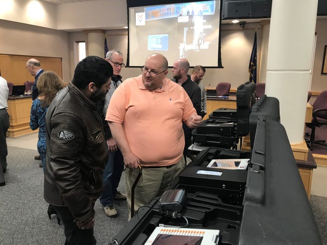 Mike Smith, on the right, works in the Tippecanoe County Election Office and shows how the county's new voting machines work during Tuesday, March 29, 2022, state-required test of the election equipment.