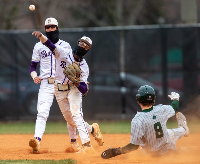 Louisville Male's DJ Grinter makes a double play in the second inning against Trinity. March 30, 2022