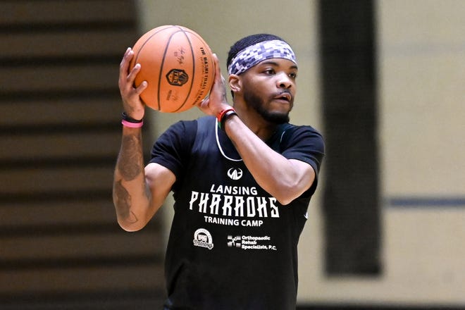 Ja'Myrin Jackson looks to pass during a Lansing Pharaohs basketball practice on Tuesday, March 29, 2022, at the Don Johnson Field House in Lansing.