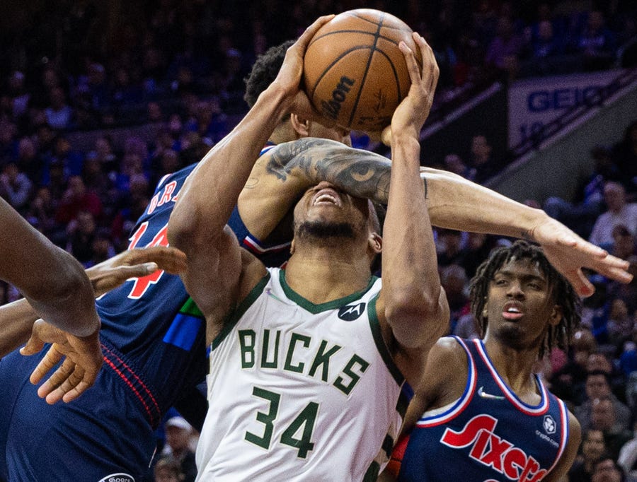 March 29: Bucks forward Giannis Antetokounmpo (34) gets fouled across the face by Sixers defender Danny Green (14) during the fourth quarter in Philadelphia.