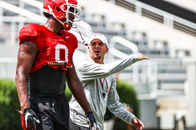 Georgia tight ends coach Todd Hartley and tight end Darnell Washington during the Bulldogs’ practice on Dooley Field at Sanford Stadium in Athens, Ga., on Tuesday, Aug. 10, 2021. (Photo by Tony Walsh)