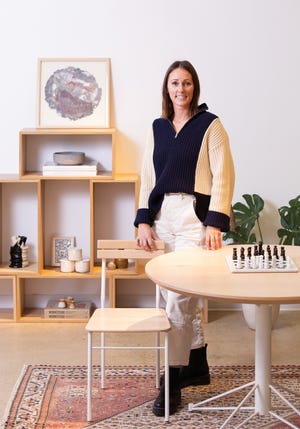 Lindsay Remley is co-owner of Edgework Creative with her husband, Alex. The company creates a variety of wooden furnishings at its Columbus warehouse, including the modular shelving, table and chair shown in the photo.