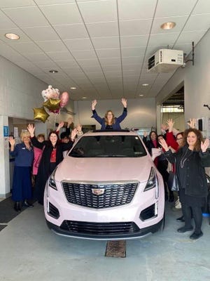 Mary Beth Spielvogel (center), recently earned her pink Cadillac through the Mary Kay Company, which represents her achievement as an independent sales director in the top 1% of the company.