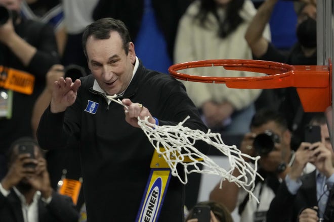 Duke head coach Mike Krzyzewski, seen here celebrating while cutting down the net after beating Arkansas in the Elite Eight, will try to finish his career with another national title like UCLA legend John Wooden did in 1975 by beating Kentucky.