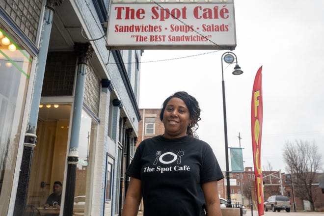 Yveline Thompson, owner of The Spot Cafe, poses outside her restaurant on Wednesday, March 30, 2022, in Rockford.