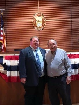 Paul and Harry Waldron stand together at the St. Johns County government auditorium in 2019.