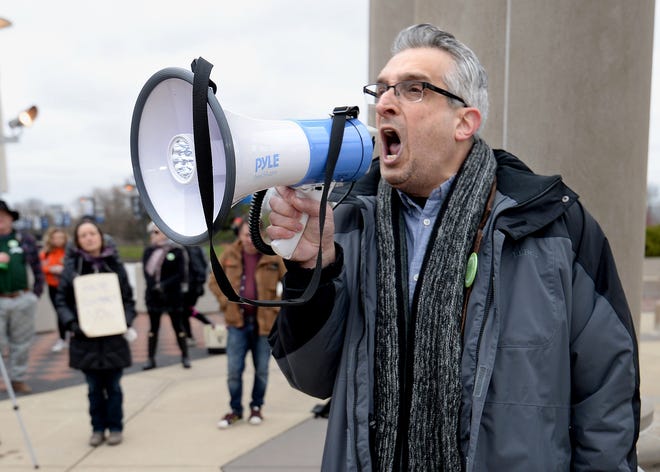University of Illinois Springfield professor of political theory and philosophy Richard Gilman-Opalsky uses a megaphone to pump up the crowd during a rally held by UIS United Faculty on Thursday. Faculty have been working without a contract since Aug. 16. Union representatives will sit down with administration representatives at talks on Friday.