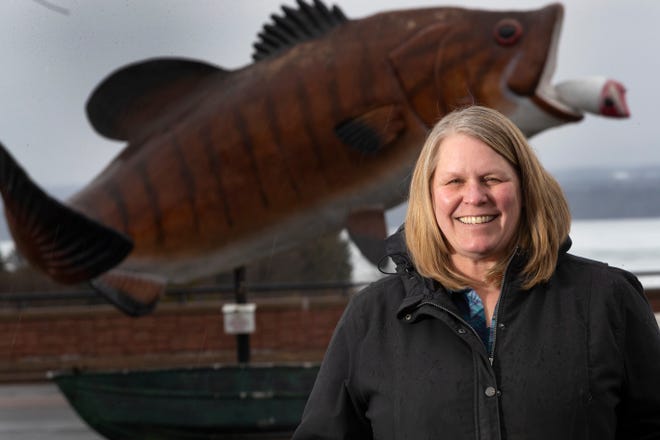 Sandra Naas stands in front of a fish statute in Ashland in early 2022.