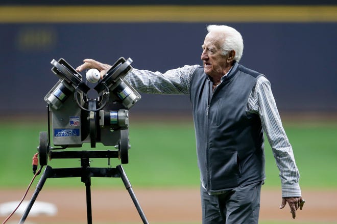 Bob Uecker throws out the first pitch using a pitching machine as he is honored for 50 years of broadcasting before the game Sept. 25 at American Family Field in Milwaukee.