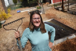 RGJ reporter Amy Alonzo poses for a portrait in her backyard garden in Reno on March 31, 2022.