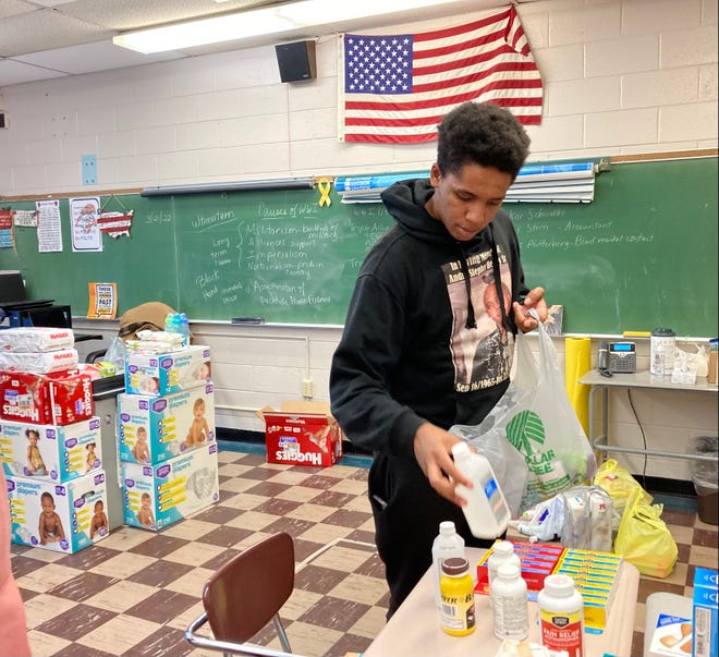 Avian Henry, 18, sorts donations raised through a collection hosted by the Vineland High School Search for Conscience class.  The items will be sent to aid Ukrainian refugees.