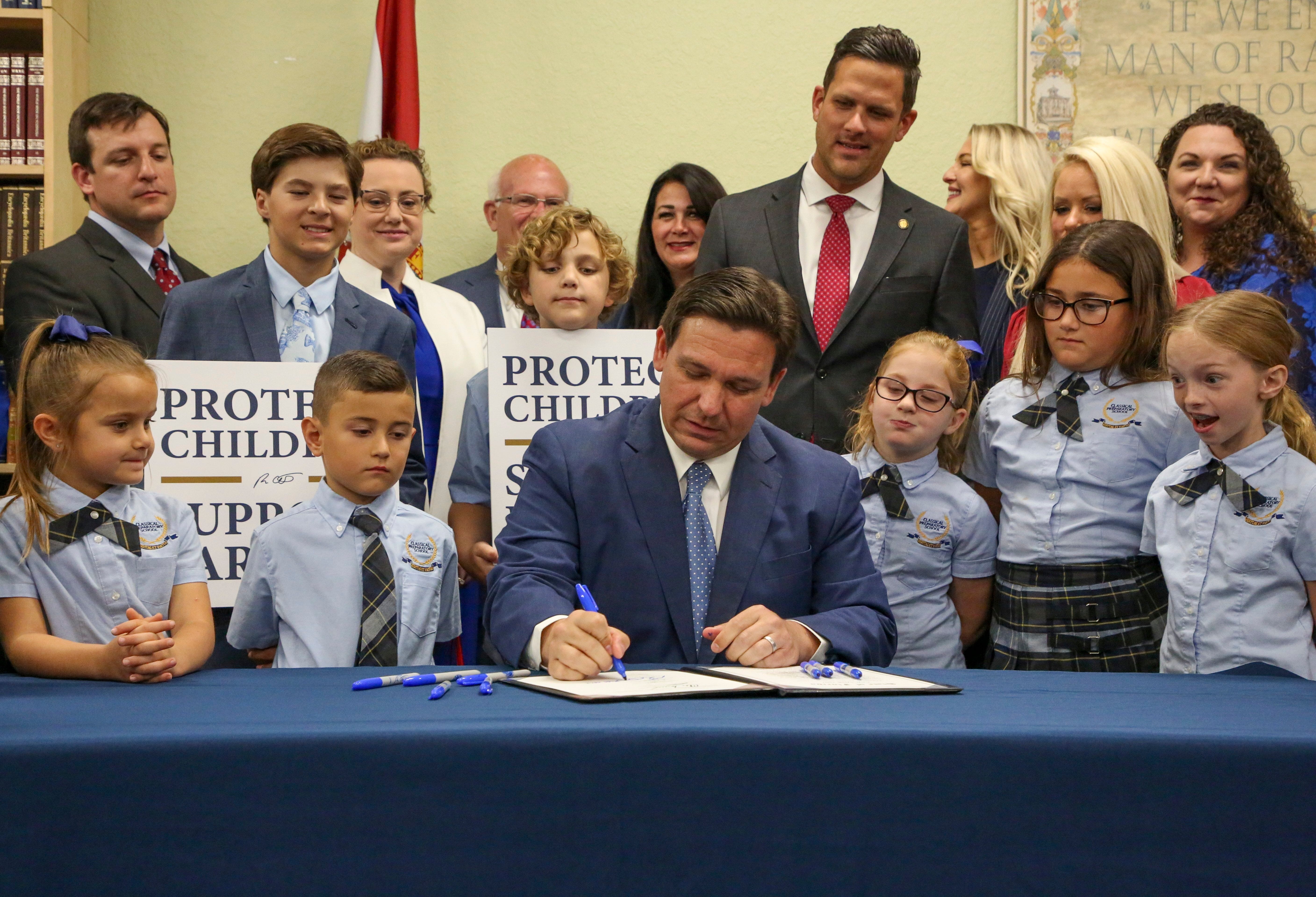 Florida Gov. Ron DeSantis signs the Parental Rights in Education bill at Classical Preparatory school Monday, March 28, 2022 in Shady Hills, Fla.