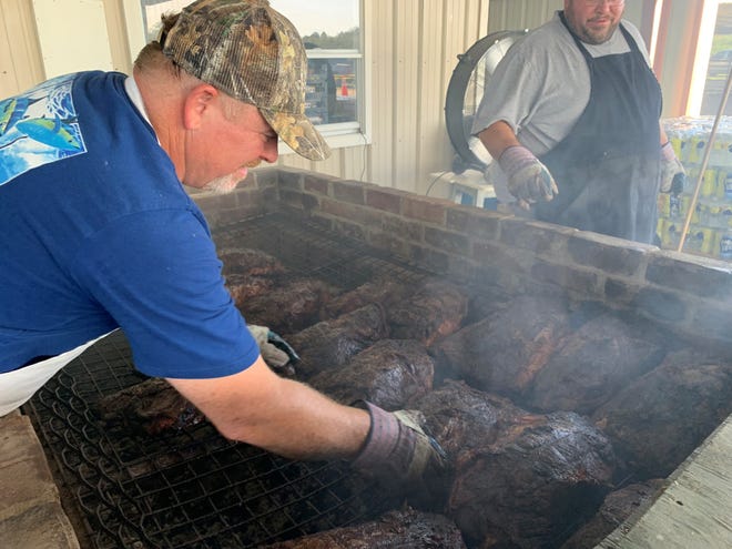Earl Buckles, Randy Buckles' son, carries on the family tradition of slow-cooking the beef for the 65th Annual Cracker Day.