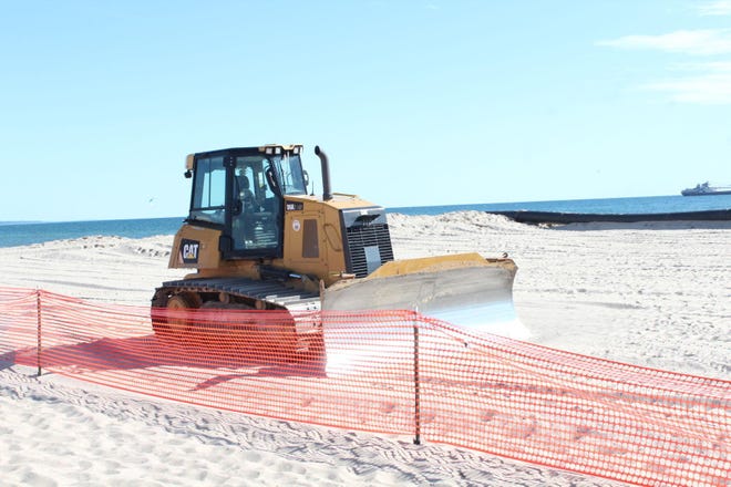 A bulldozer moves sand for a previous dredging project in Grand Haven’s harbor in June 2021. The U.S. Army Corps of Engineers has been awarded $3.4 million this year to be used for Grand Haven projects, including dredging the channel.
