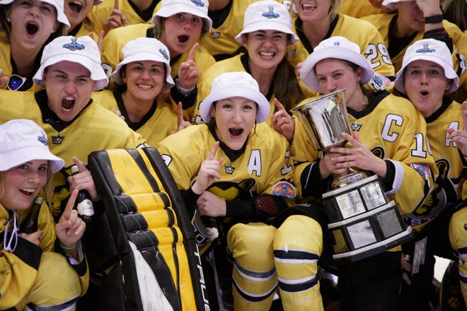 Boston Pride defender Kaleigh Fratkin, wearing the's' alternate captain and Isobel Cup captain Jillian Dempsey, leads the celebration after the team won its second straight league title by beating the Connecticut Whale, 4-2, in the Wesley Chapel, Florida, March 28, 2022.
