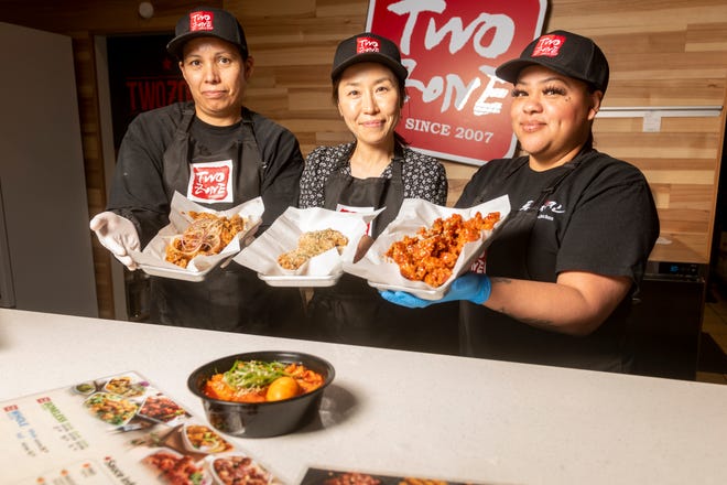 Jenny Choe, co-owner, with staff members Dulce, left, and Jennifer, right, display three of the many Twozone Chicken menu choices.