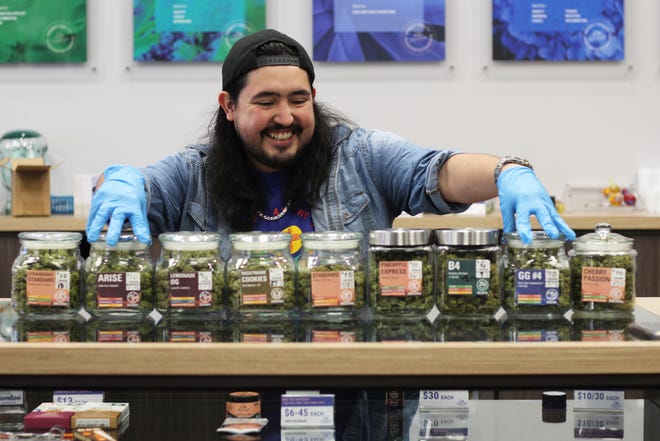 Austin De La O, assistant manager at Everest Cannabis Co., shows off all the different flower strains the dispensary offers. He said one of the most popular has been Nightmare Cookies. April 1, 2022, marked the first day of recreational cannabis sales in New Mexico.