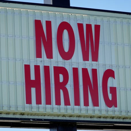 MIAMI, FLORIDA - DECEMBER 03:  A Now Hiring sign hangs in front of a Winn-Dixie grocery store on December 03, 2021 in Miami, Florida.  The Labor Department announced that payrolls increased by just 210,000 for November, which is below what economists expected, though the unemployment rate fell to 4.2% from 4.6%.  (Photo by Joe Raedle/Getty Images)