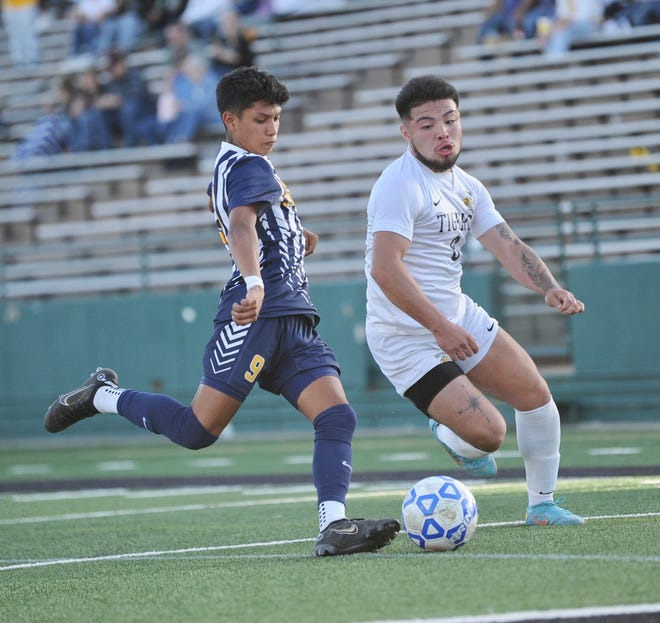 Stephenville's Anferny Moreno prepares to boot a ball away from Snyder's Jorge Olivares Friday.