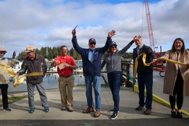 Commissioners past and present and others who worked on the Keyport Marina project celebrate the opening with a ribbon-cutting Saturday.
