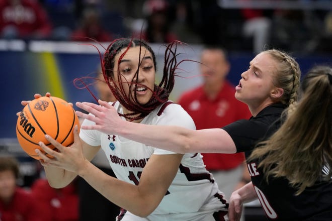 South Carolina's Brea Beal tries to shoot past Louisville's Hailey Van Lith during the first half of a college basketball game in the semifinal round of the Women's Final Four NCAA tournament Friday, April 1, 2022, in Minneapolis. (AP Photo/Charlie Neibergall)
