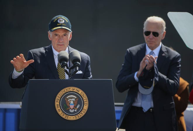 U.S. Senator Tom Carper delivers the principal address as President Joe Biden looks on during the celebration of commissioning for the USS Delaware attack submarine at the Port of Wilmington on the Delaware River Saturday, April 2, 2022.