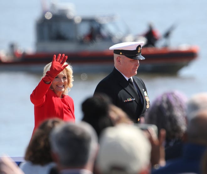First Lady Jill Biden, the ship's sponsor, is escorted to the platform during the celebration of commissioning for the USS Delaware attack submarine at the Port of Wilmington on the Delaware River Saturday, April 2, 2022.