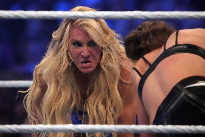 Charlotte Flair looks at Ronda Rousey  as they battle for the Smackdown Women’s Championship.