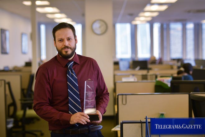 Telegram & Gazette reporter Brad Petrishen holds the Michael Donoghue Freedom of Information Award presented to the newspaper by the New England First Amendment Coalition.