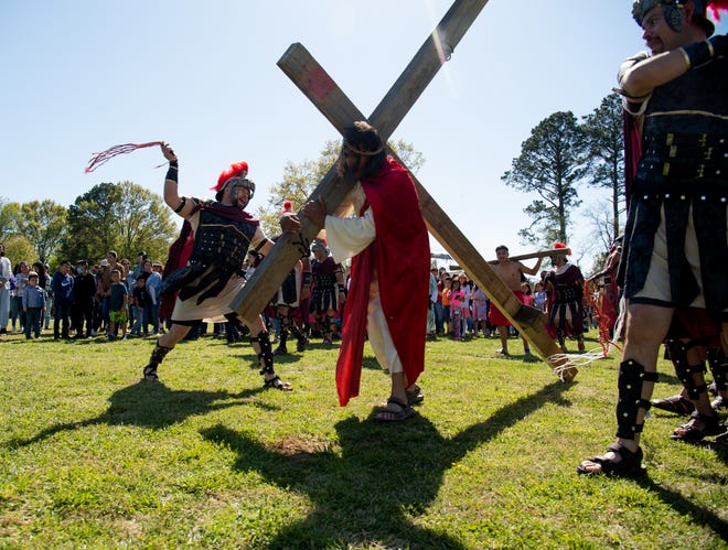 The Hispanic Community of Holy Spirit Catholic Church enact the Stations of the Cross Sunday, April 3, 2022. A Roman soldier scourges Jesus who is portrayed by Luis Enrique. Gary Cosby Jr./Tuscaloosa News