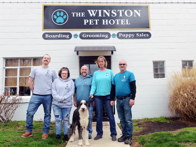 Joan Batstra, with her dog Winston, and husband Todd, celebrated their fifth anniversary on April 1. After starting off with one employee, they have added night watch Todd Ritchie, left, groomer Chelsie Still and manager Shane Cooper to their operation, which now includes breeding and grooming.